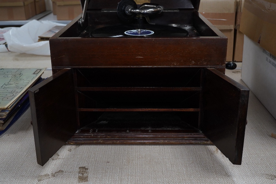 A mahogany cased HMV table top gramophone record player and a small selection of 78 rpm records. Condition - fair to good.